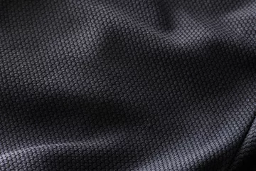 Rolgordijnen Close-up polyester stof textuur van zwart atletisch shirt © spyarm