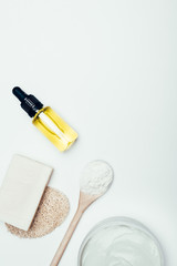 top view of soap, sponge, spoon, clay mask in container and clay powder isolated on white surface