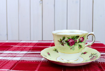 English tea cup and saucer on red tablecloth