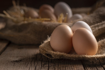 Fresh eggs on wooden dark table