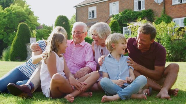 Three generation family laughing together in the garden