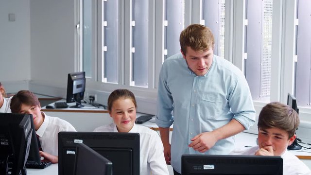 Teenage Students Wearing Uniform Studying In IT Class