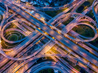 Top view of Highway road junctions at night. The Intersecting freeway road overpass the eastern outer ring road of Bangkok, Thailand.