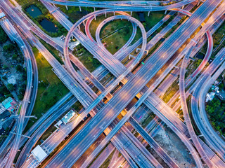 Top view of Highway road junctions at night. The Intersecting freeway road overpass the eastern...
