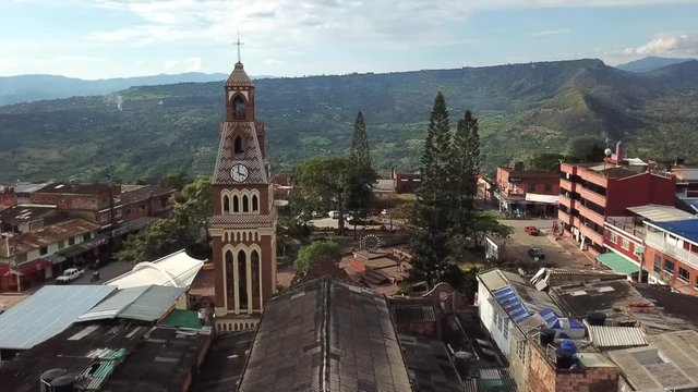 Beautiful aerial cinematic footage of the church and town in Colombia mesitas del colegio 