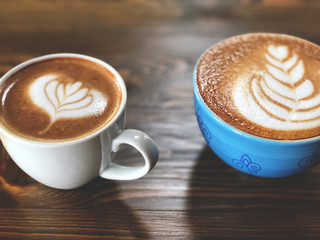 Piccolo latte art coffee cup and cappuccino  cup on the wooden table. Choose your cup. Love coffee , wake up and full fill energy. Choose your cup. Vintage style