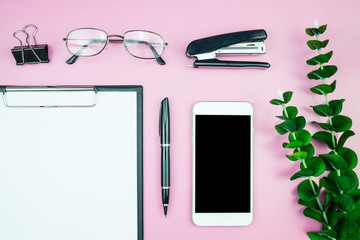 Flat lay photo with Creative header design mockup set of workspace desk with blank of free copy space screen smartphone Tropical Leave on Pink Pastel background, Technology concept minimal style.