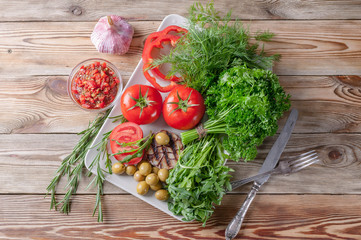 Fresh vegetables and herbs. Red tomatoes, red sweet peppers, parsley, dill, arugula, garlic, rosemary. Bio healthy food concept. Top view