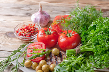 Fresh vegetables and herbs. Red tomatoes, red sweet peppers, parsley, dill, arugula, garlic, rosemary. Bio healthy food concept.