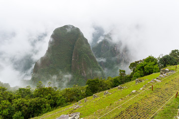 Putucusi (Phutuq K'Usi) mountain and Machu Picchu's citadel terraces, in Peru