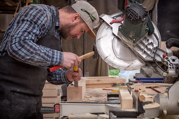 Carpenter work with circular saw for cutting boards, the man sawed bars, construction and home renovation, repair and construction tool