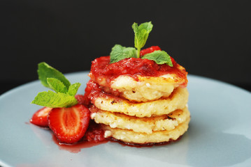 Cottage Cheese Pancakes with Strawberry and Strawberry Jam, mint Leaves. Sweet Morning Breakfast. black Background.