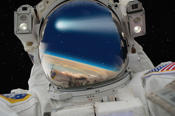 An astronaut watching comet on the Earth "Elements of this image furnished by NASA © muratart