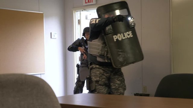 A SWAT police team moves to make a combat assault in counterterrorism training.