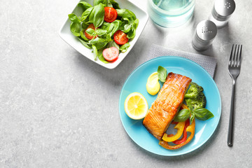 Tasty cooked salmon with vegetables served for dinner, top view