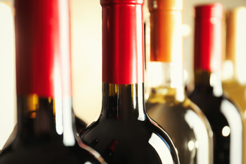 Bottles with delicious wine, closeup. Professional sommelier