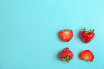 Flat lay composition with with tasty ripe strawberries on color background