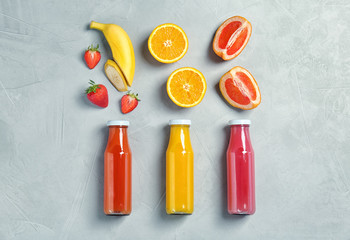 Flat lay composition with tasty juices and ingredients on light background