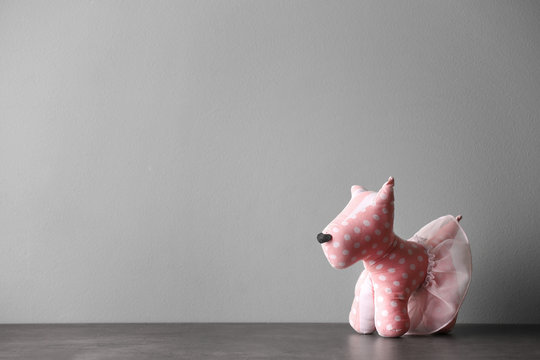 Abandoned toy dog on table against light background. Time to visit child psychologist