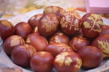 Easter eggs of red color with a pattern of leaves 