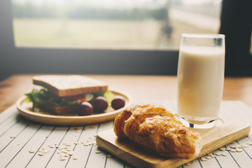 Homemade sandwich with orange juice on wood table