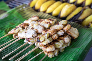 Grilled slice Banana skewers on green banana leaf,  in Thailand traditional style. Thai banana sweet dessert