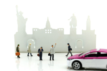 Miniature people : businessman waiting for a taxi in front of the airport,business meeting concept.