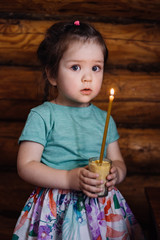 little girl holding a candle