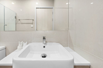 Close-up small basin and mirror in bathroom