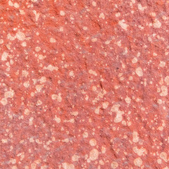 Red rough stone texture background. Material construction and architectural detail.