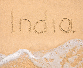 The word India written in the sand on beach