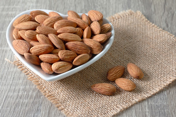 Almond group in a heart-shaped white cup