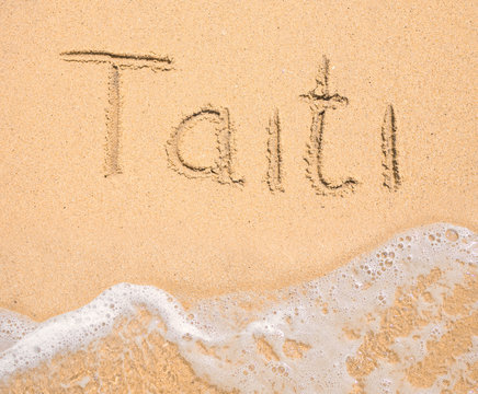 The word Taiti written in the sand on beach