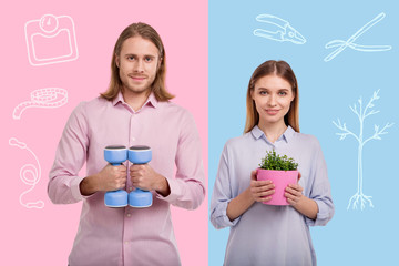 Satisfied with hobbies. Positive adorable loving couple looking satisfied with their new hobbies while standing with hand weights and a flower pot