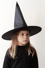 Girl in black witch costume close-up portrait