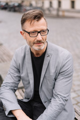 Portrait of mature, metro man sitting casually