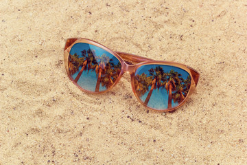 sun glasses with palms reflection on the beach mixed media