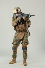 Soldier in camouflage holding rifle