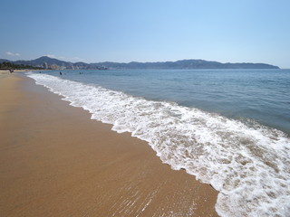 Wonderful landscape of sandy beach at bay of ACAPULCO city in Mexico and waves of Pacific Ocean