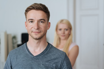Young man smiling quietly at the camera
