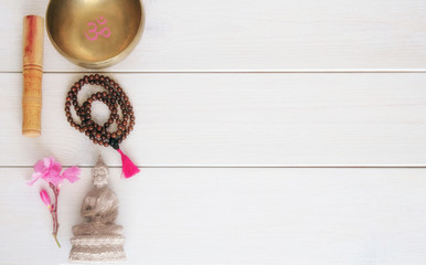 Meditation or mindfulness concept. Wooden mala beads, tibetan singing Bowl with symbol OM  and...