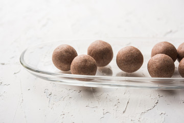 Nachni laddu or Ragi laddoo or balls made using  finger millet, sugar and ghee. It's a healthy food from India. Served in a bowl or plate over moody background. Selective focus