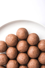 Fototapeta na wymiar Nachni laddu or Ragi laddoo or balls made using finger millet, sugar and ghee. It's a healthy food from India. Served in a bowl or plate over moody background. Selective focus