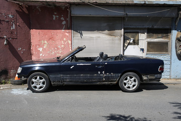 A wrecked classic convertible car  in the street in Istanbul