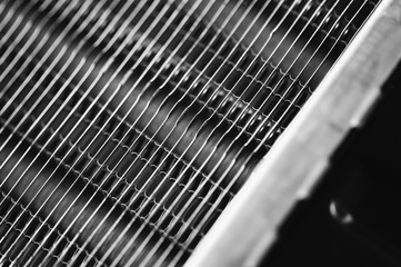 Part of the radiator for cooling the engine close-up. Steel texture.