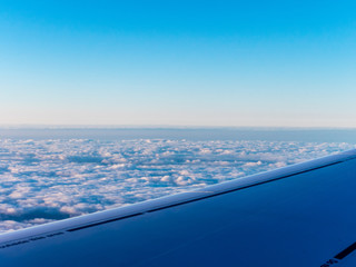 Wing with sky and clouds