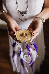 wedding rings in the hands of the bride bohemian style