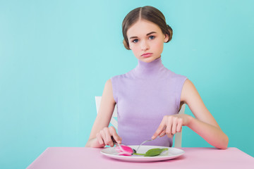 beautiful teen girl on diet eating tulip flower