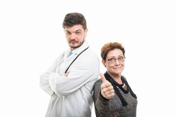 Male doctor and female senior patient showing like gesture