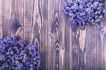 bright lilac flowers on a beautiful wooden background with copy space.